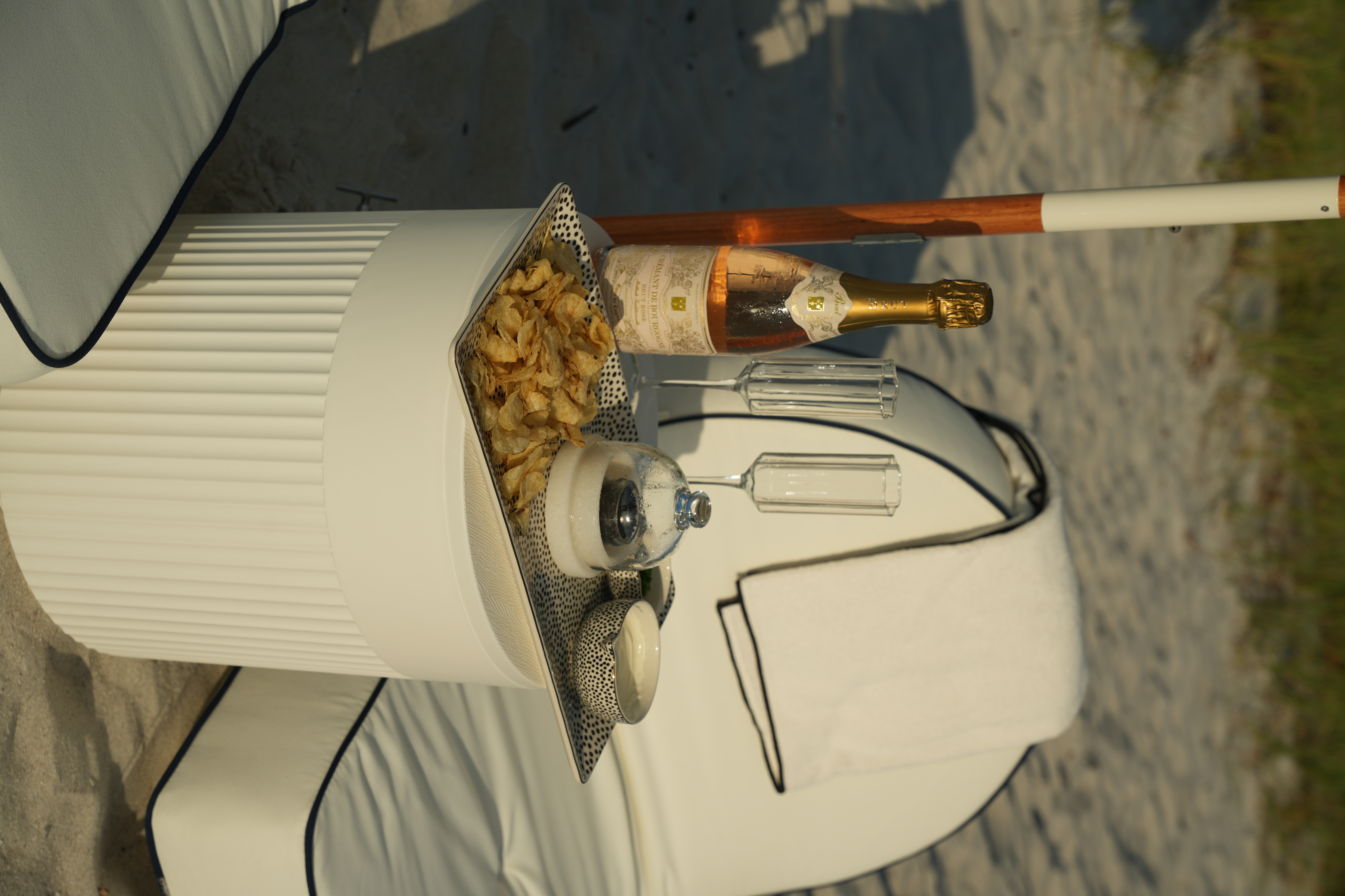 Chilled rosé, champagne flutes, and a styled tray at golden hour