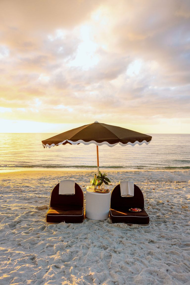 A styled beach setup at golden hour in Naples
