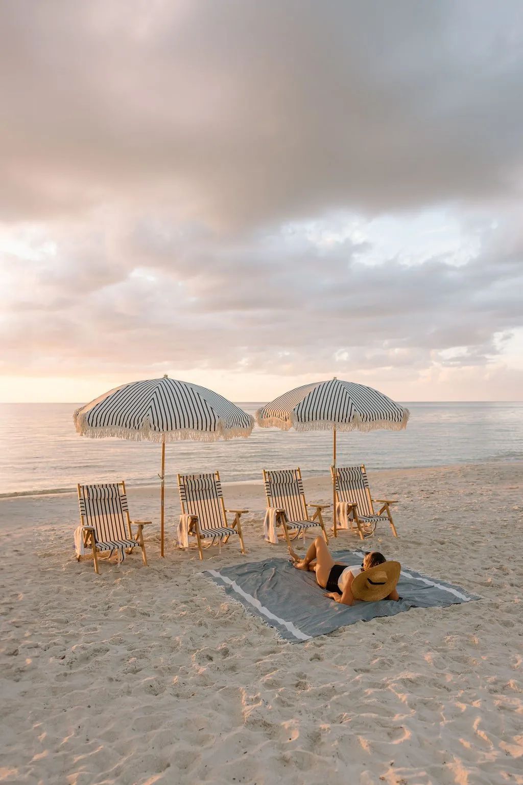 Four beach chairs set and ready on the Naples sand